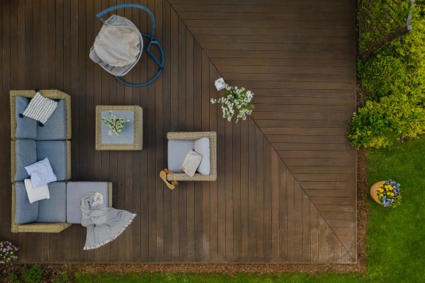 Top view of wooden terrace with comfortable wicker garden furniture